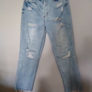 Women's high rise destroyed button fly jeans.